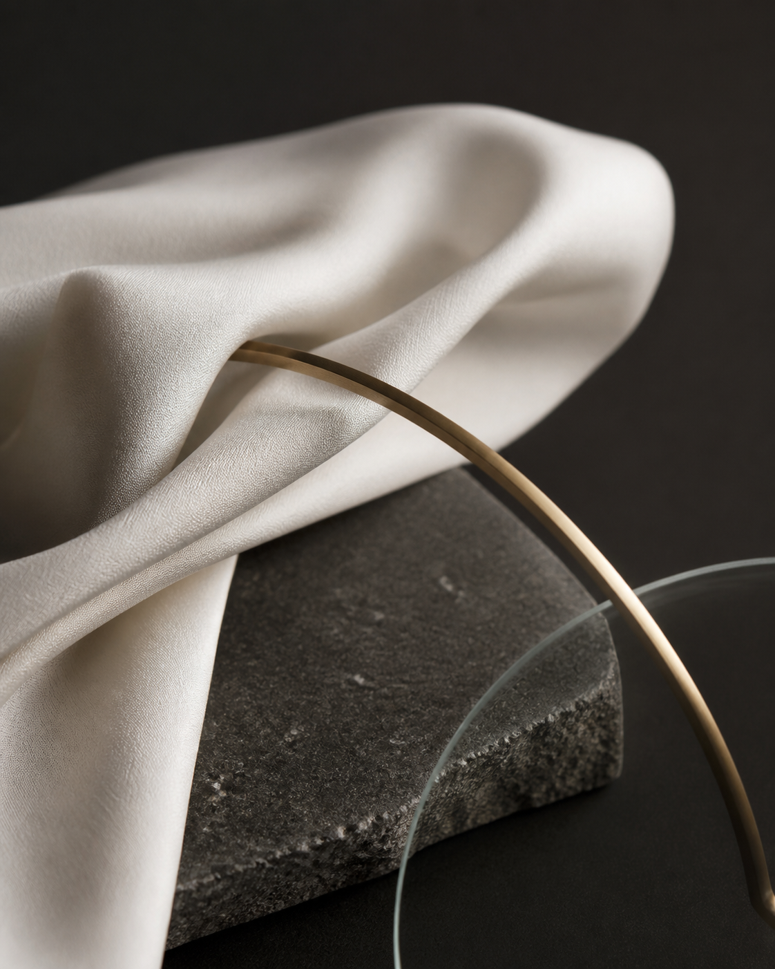 Editorial material study in pearl ivory, charcoal stone, and muted champagne